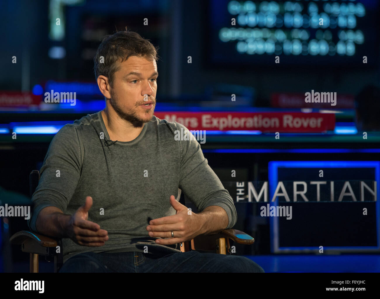 Actor Matt Damon sits in mission control for an interview during a visit to the Jet Propulsion Laboratory August 18, 2015 in Pasadena, California. Damon stars as Astronaut Mark Watney in the film 'The Martian' and visited with NASA scientists and engineers who served as technical consultants on the film. Stock Photo