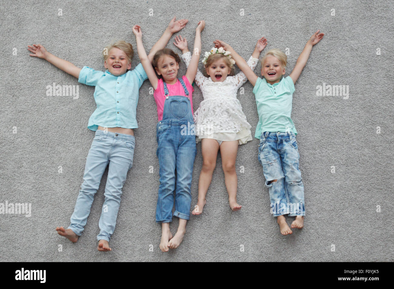 happy kids lying on the floor Stock Photo Alamy