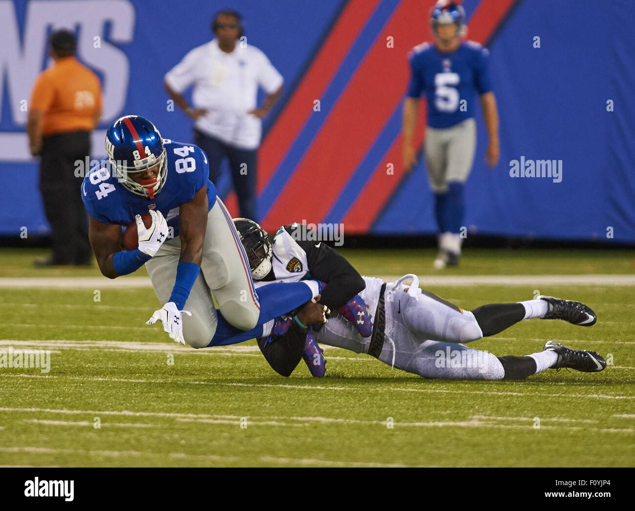 East Rutherford, New Jersey, USA. 22nd Aug, 2015. Giants' tight end Larry Donnell (84) is tackled by Jaguars' safety Craig Loston (20) in the first half during preseason action between the Jacksonville Jaguars and the New York Giants at MetLife Stadium in East Rutherford, New Jersey. Duncan Williams/CSM/Alamy Live News Stock Photo