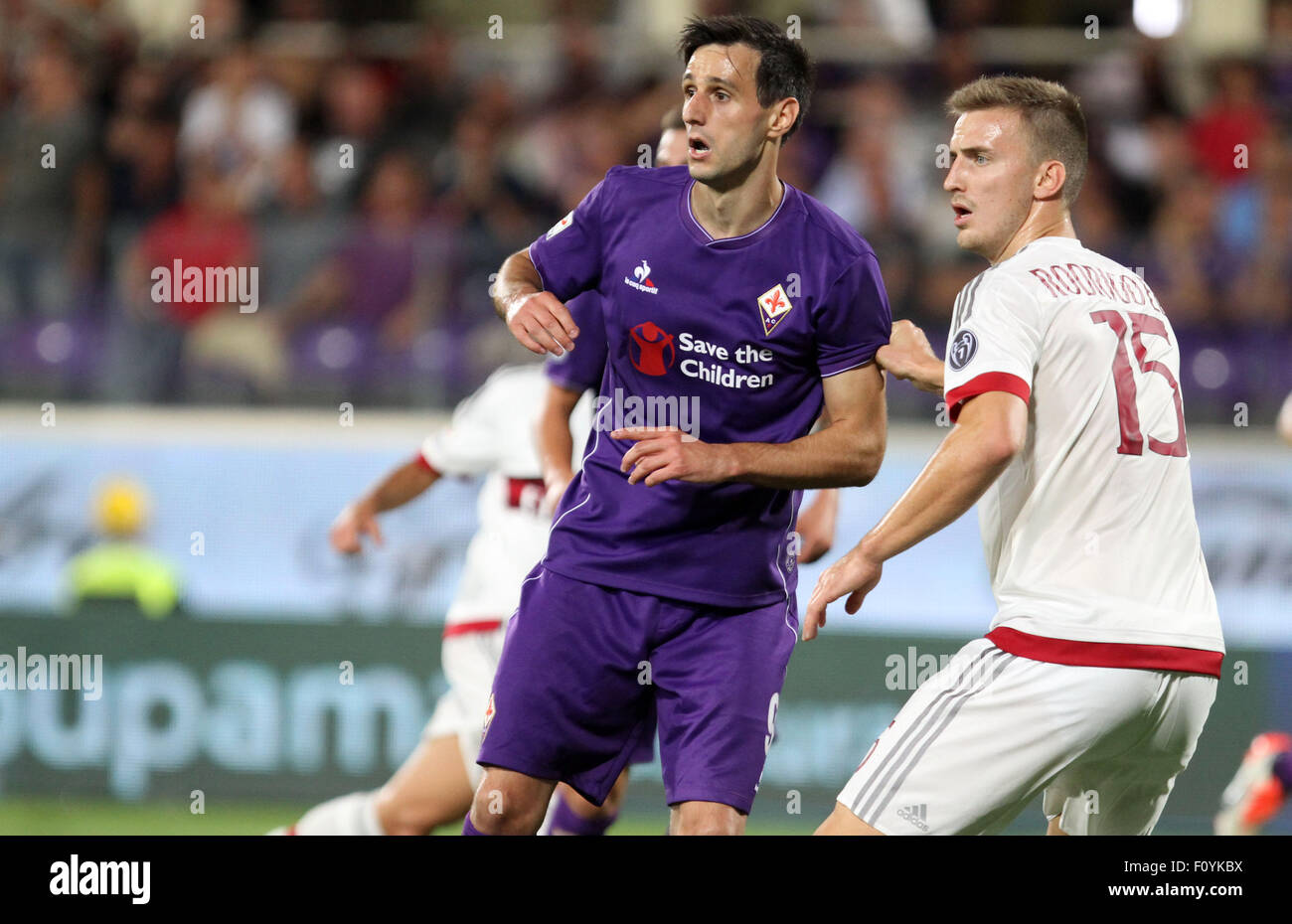 Florence, Italy, 23rd Aug, 2015. Fiorentina's forward Nikola Kalinic and  Milan's defender Rodrigo Ely (R) during the Italian Serie A football match  between ACF Fiorentina v AC Milan on 23th August, 2015