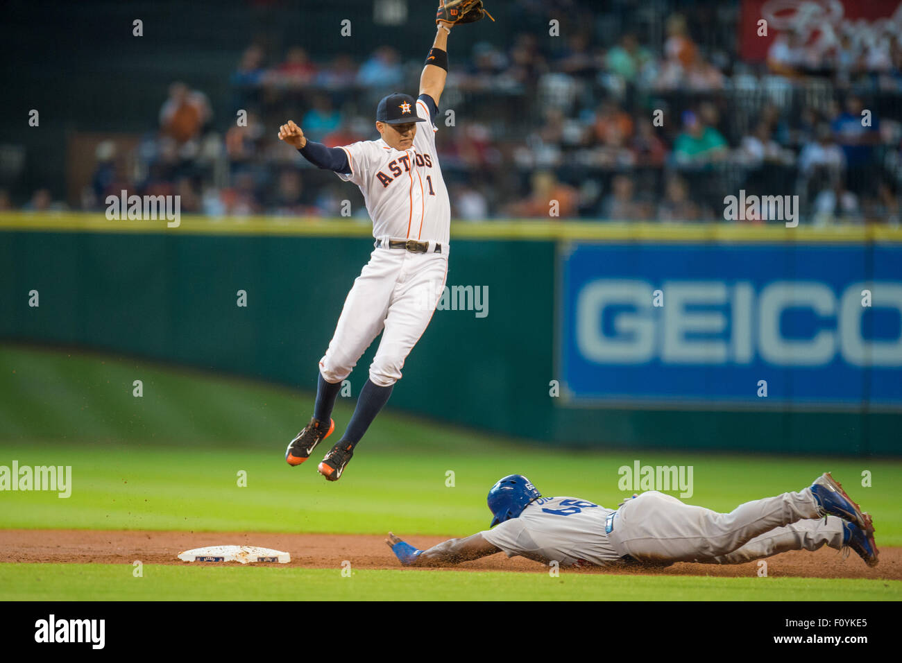 Houston, TX, USA. 23rd Aug, 2015. Los Angeles Dodgers right fielder Yasiel Puig (66) safely steals second base as a high throw to Houston Astros shortstop Carlos Correa (1) pulls him off the base during the 2nd inning of a Major League Baseball game between the Houston Astros and the Los Angeles Dodgers at Minute Maid Park in Houston, TX. Trask Smith/CSM/Alamy Live News Stock Photo