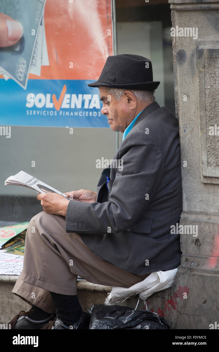 Man sitting in street reading newspaper, Valparaiso, Chile Stock Photo