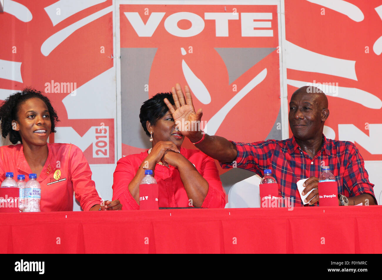 Arouca, Trinidad. 22nd August, 2015. Dr. Keith Christopher Rowley (R), Leader of Opposition and Member of the House of Representatives for Diego Martin West waves to supporters at a rally for People's National Movement (PNM) constituents of Lopinot/Bon Aire West during the General Elections campaign on August 22, 2015 in Arouca, Trinidad.  Dr. Rowley is the candidate of the People's National Movement to become Prime Minister when elections are held on September 07, 2015.  (Photo by Sean Drakes/Alamy Live News) Stock Photo