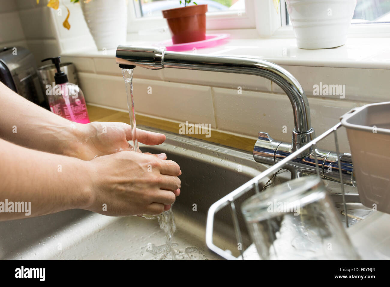 washing hands in a kitchen Stock Photo Alamy