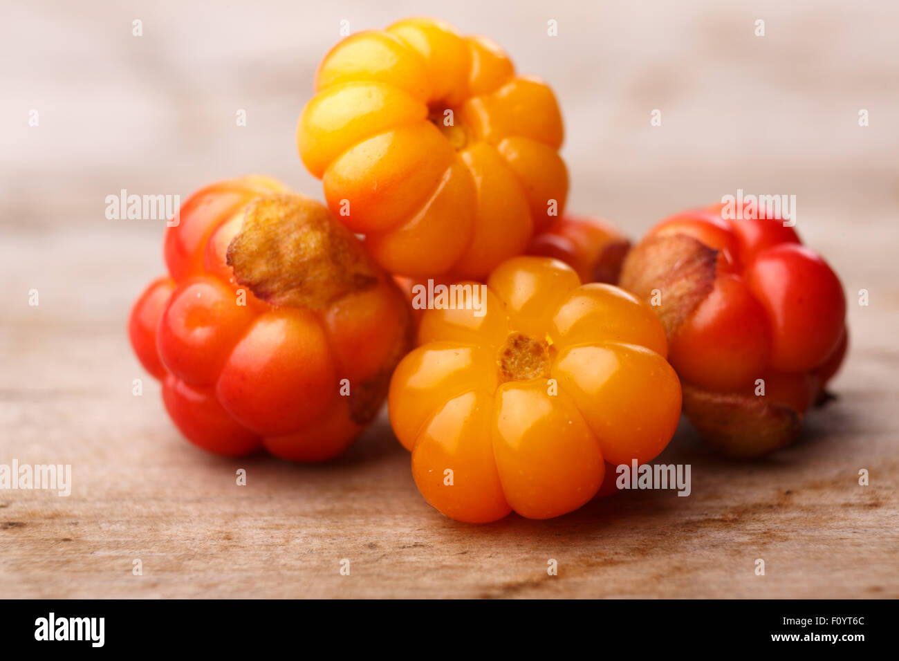 Cloudberries (moroshka) on a wooden table. Wild northern berry. Shallow  depth of field Stock Photo - Alamy