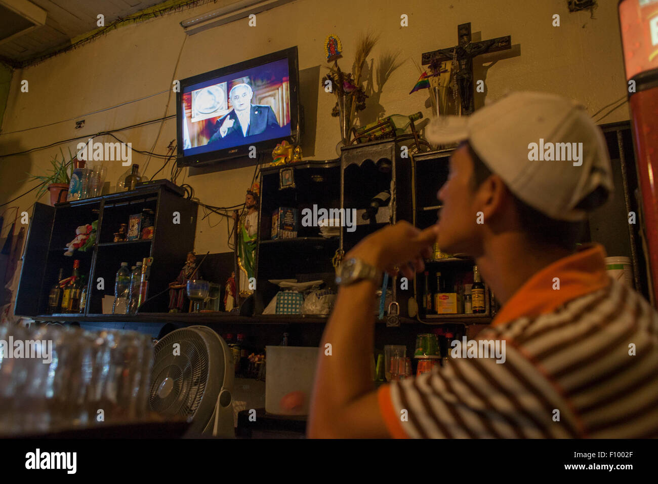 (150824) -- GUATEMALA CITY, Aug. 24, 2015 (Xinhua) -- A man watches TV as Guatemala's President Otto Perez Molina delivering a speech, in Guatemala City, Guatemala, on Aug. 23, 2015. President Otto Perez Molina says he won't resign from office despite investigators saying he may have been involved in a customs fraud scandal that has thrown the country into political crisis. (Xinhua/Luis Echeverria) Stock Photo