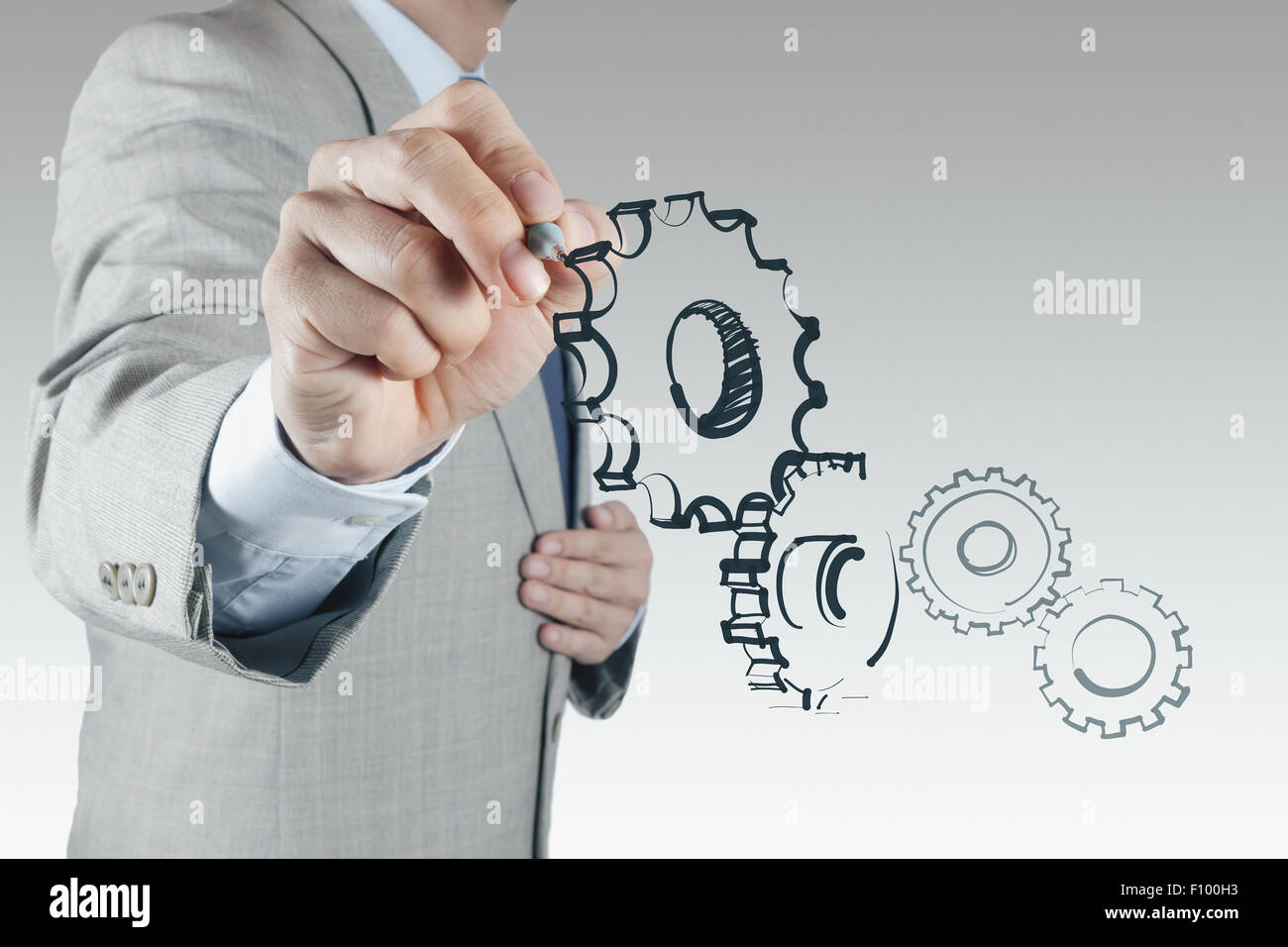 businessman hand draws gear to success concept Stock Photo - Alamy