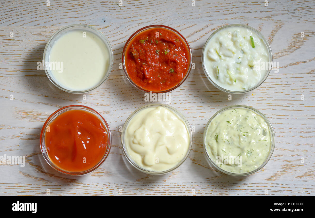 different types of sauces on wooden table Stock Photo