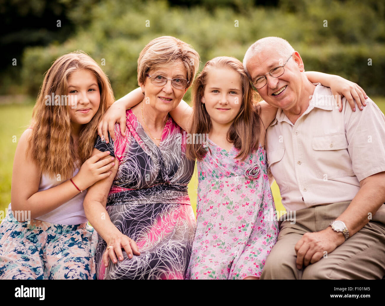 Portrait of grandparents with grandchildren - outdoor in nature Stock Photo