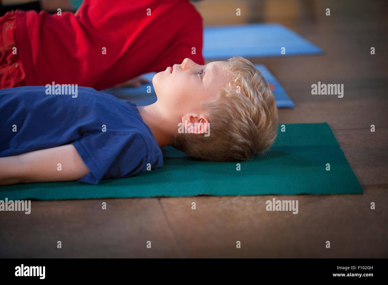 CHILD PRACTICING YOGA Stock Photo