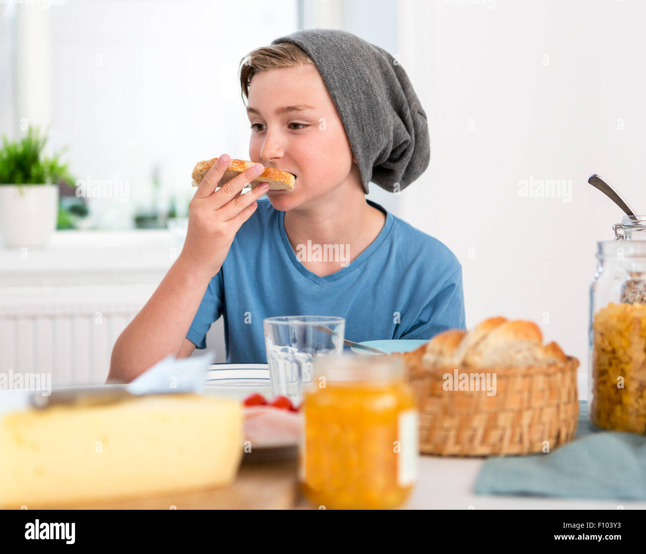 Teenage boy eating breakfast in the kitchen Stock Photo