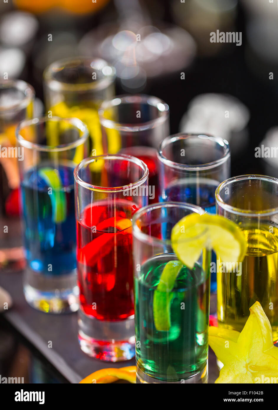 Colored alcoholic shots on bar counter Stock Photo