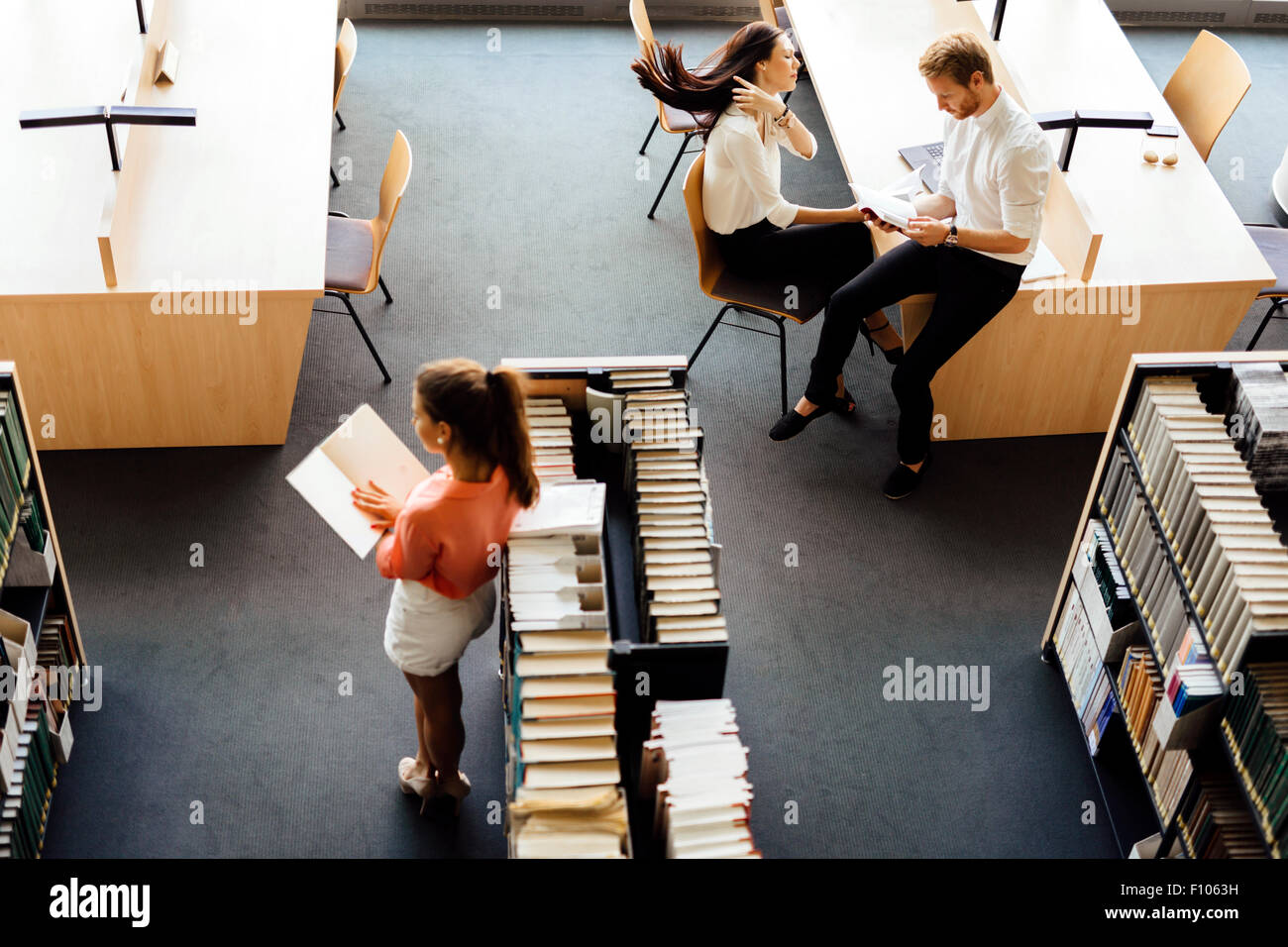 Group of students studying in a library and educating themselves Stock Photo