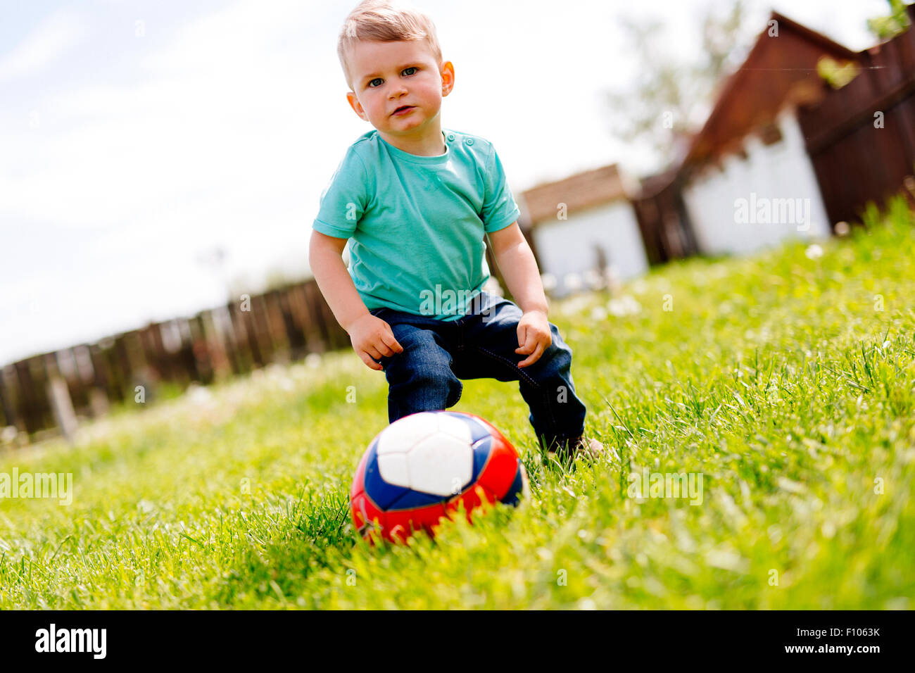 Adorable Small Boy Playing With A Soccer Ball Outdoors Stock Photo Alamy