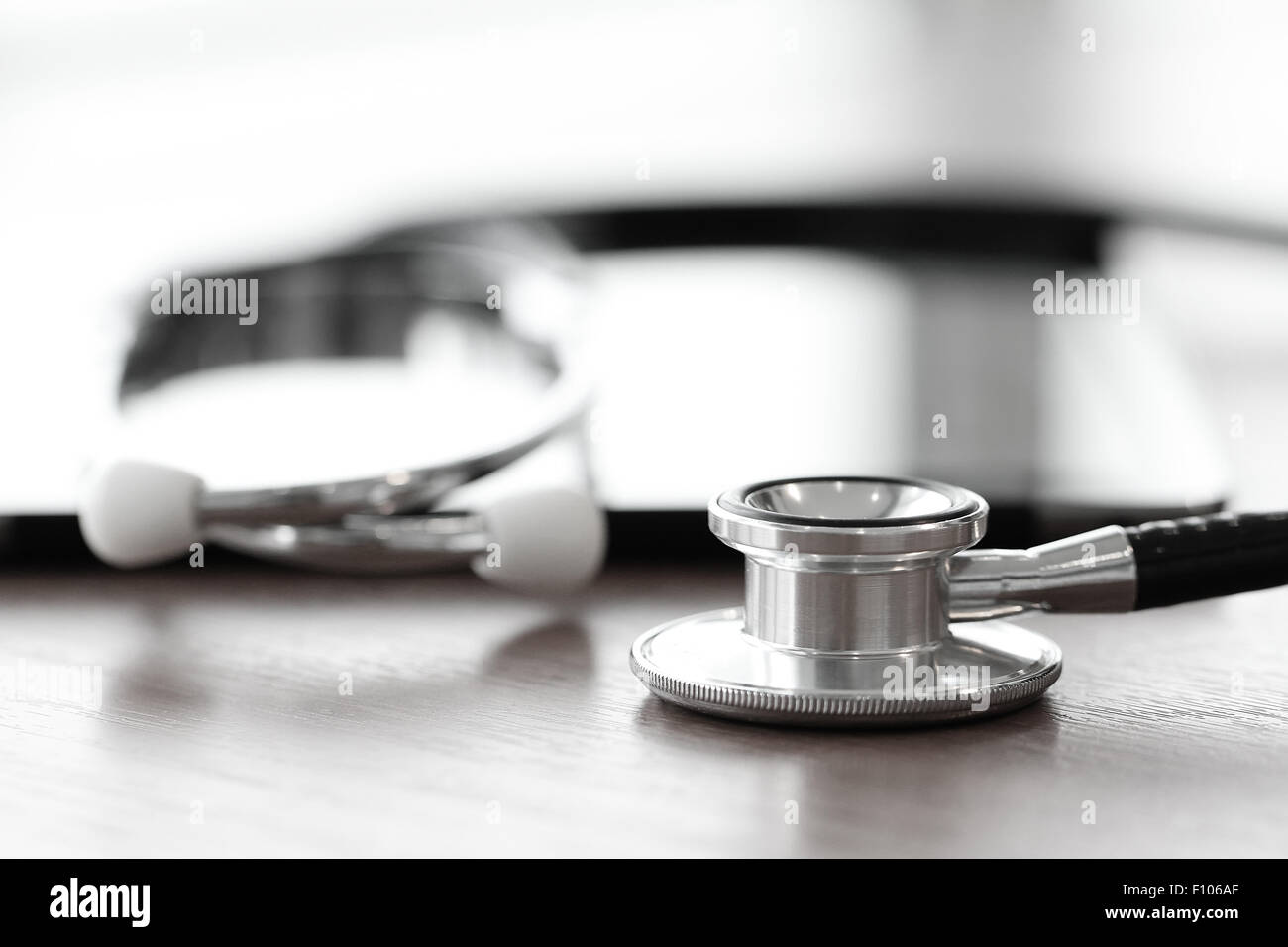 Stethoscope with digital tablet computer on wooden table and background ...