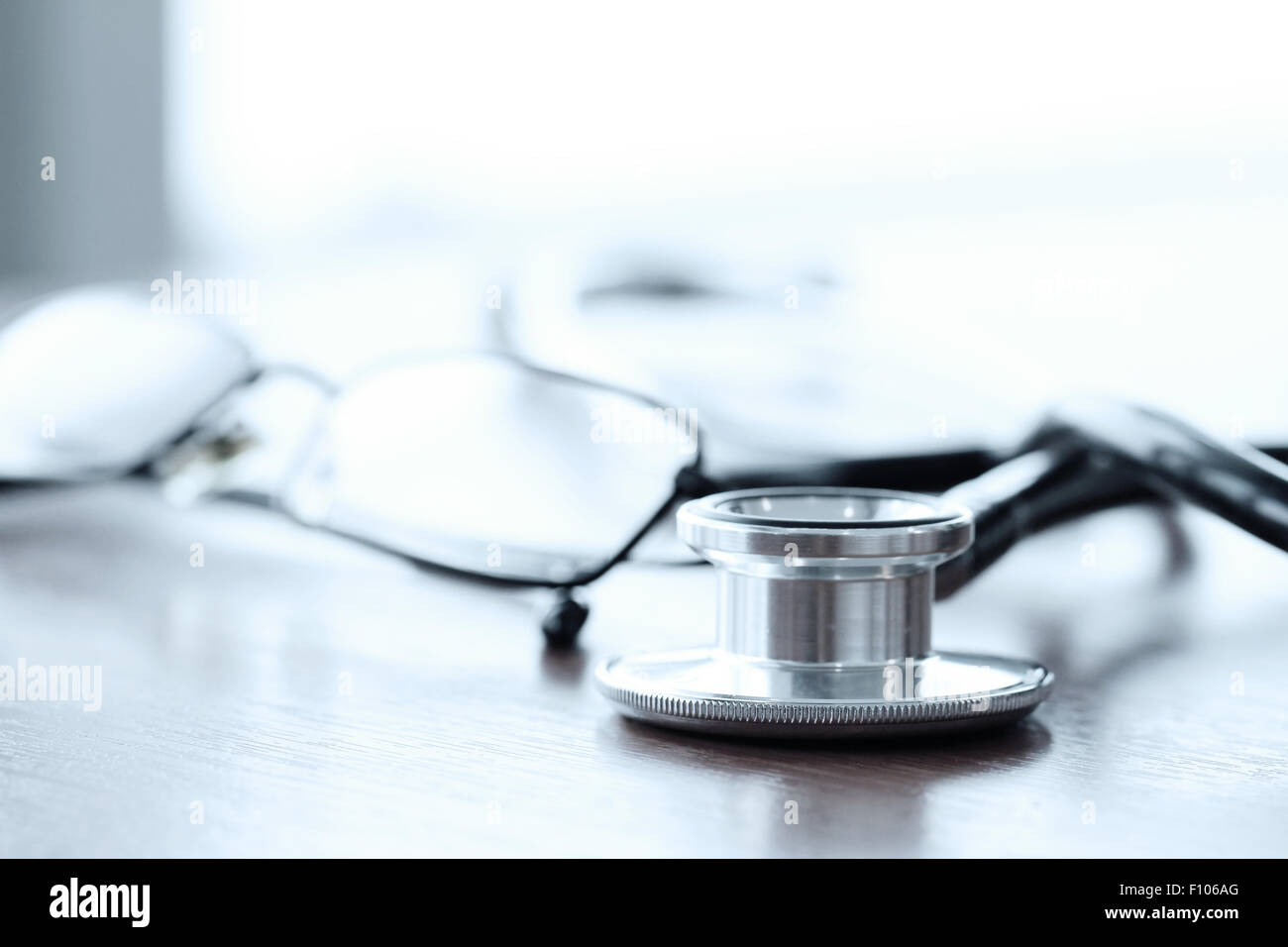 Stethoscope with digital tablet computer on wooden table and background ...