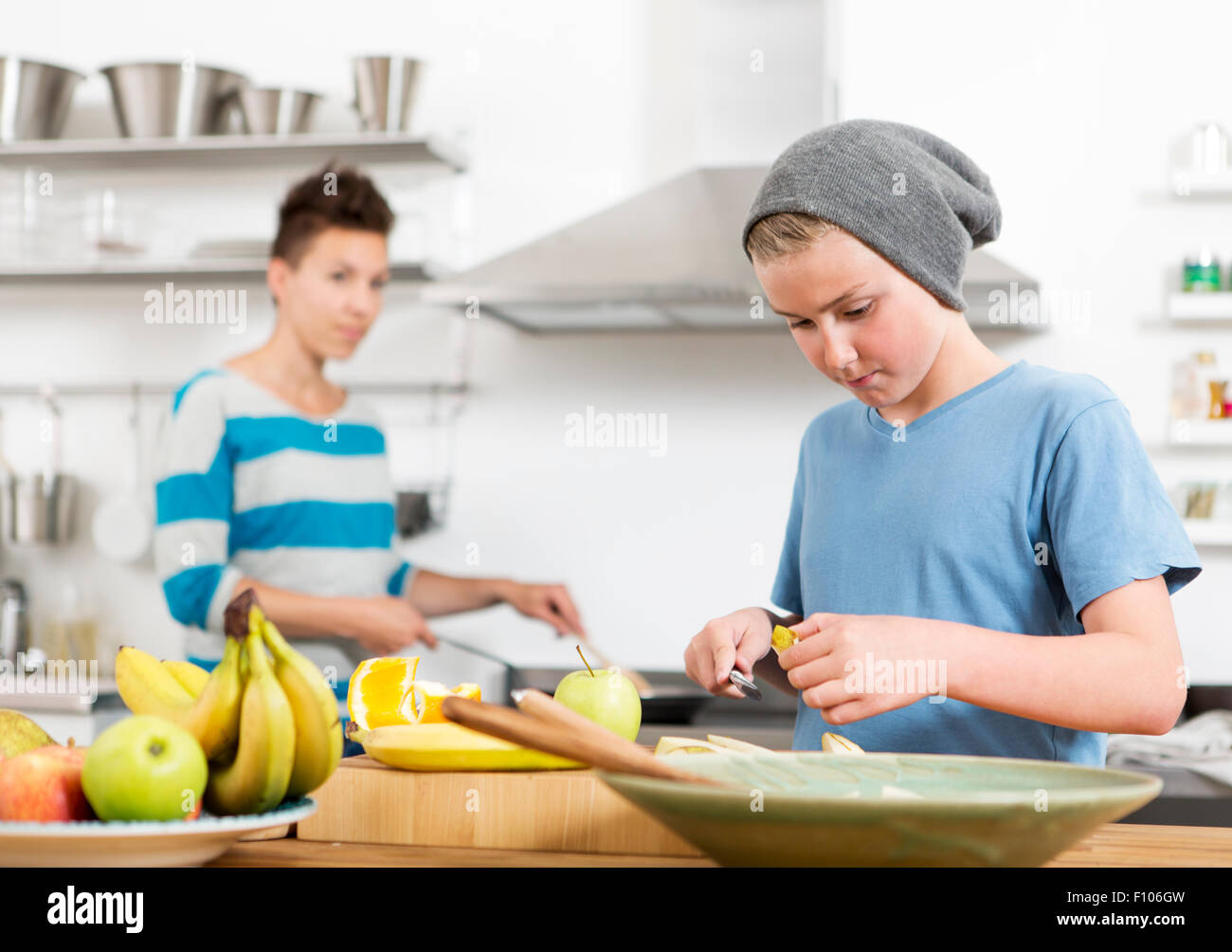 Mother and son in the kitchen preparing food together Stock Photo