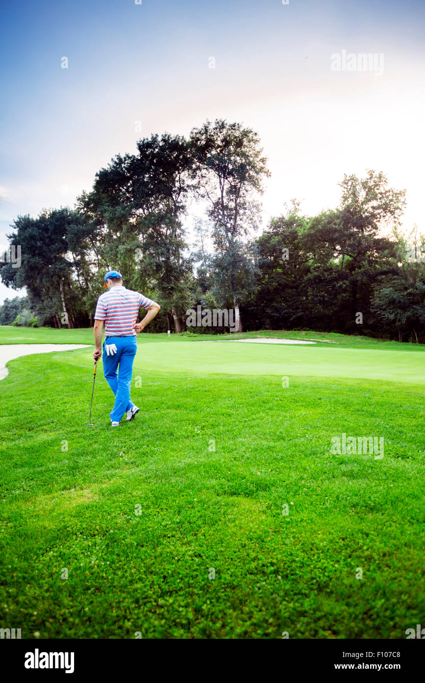 beautiful scenery with a golfer, course, sunset landscape Stock Photo
