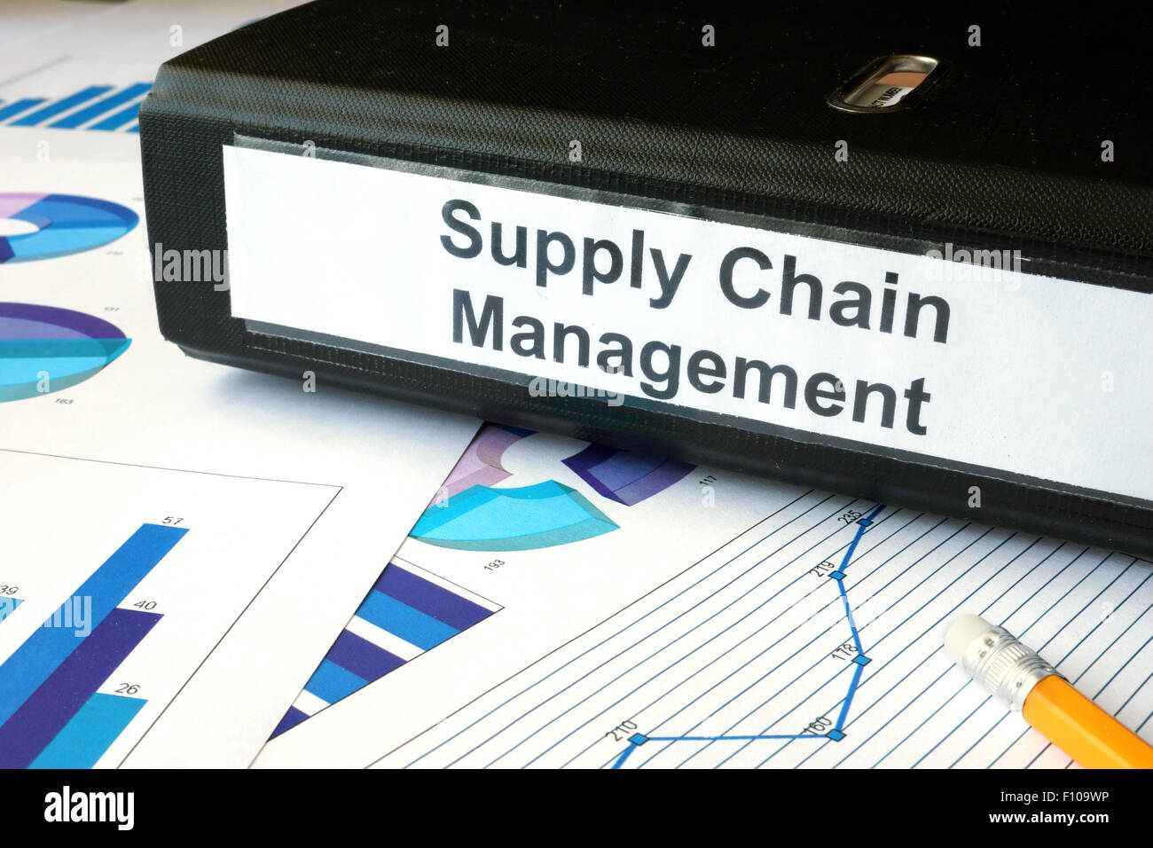 Graphs and file folder with label supply chain managment. Business concept. Stock Photo