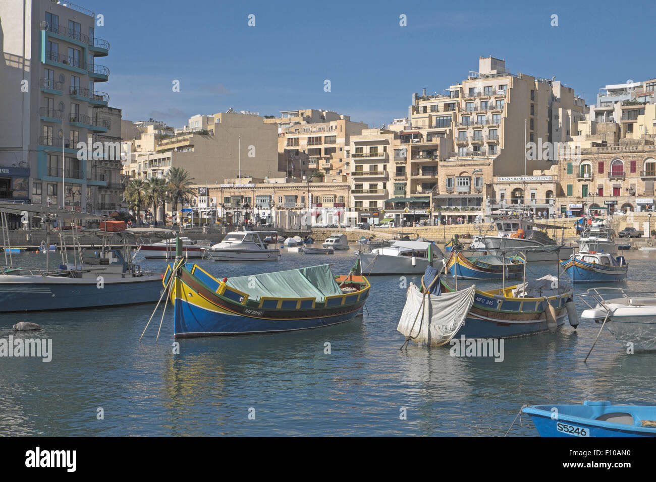 Brightly painted boats in St Julian's Bay, St Julien's, Malta. Stock Photo