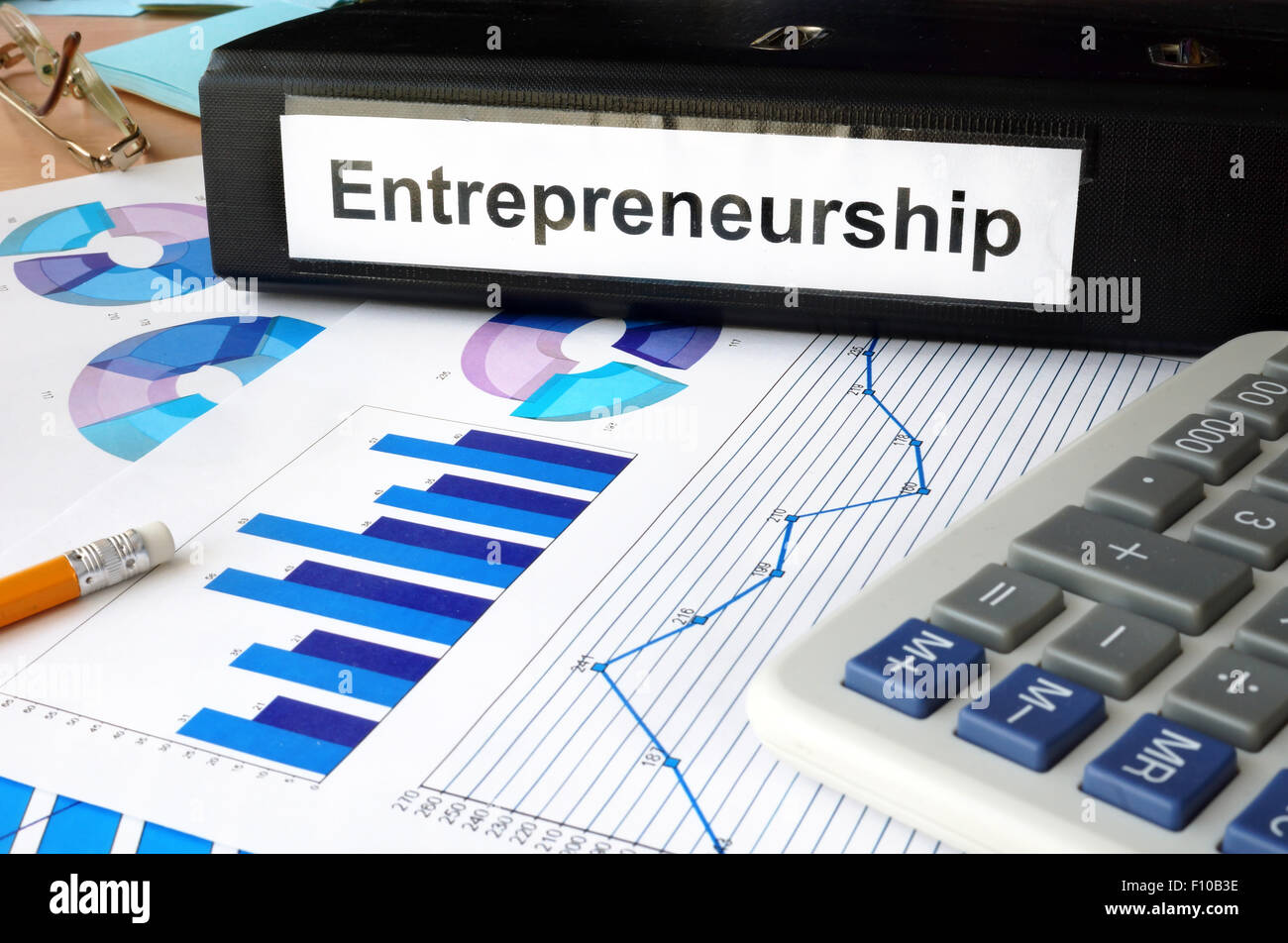 Folder with the label entrepreneurship and charts. Stock Photo