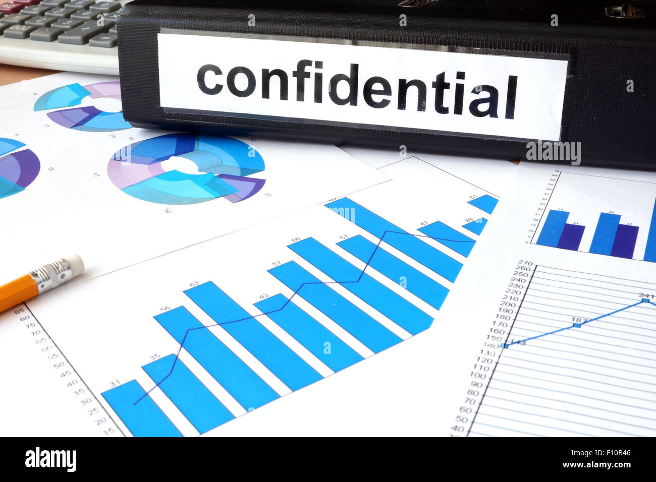Folder with the label confidential and charts. Stock Photo
