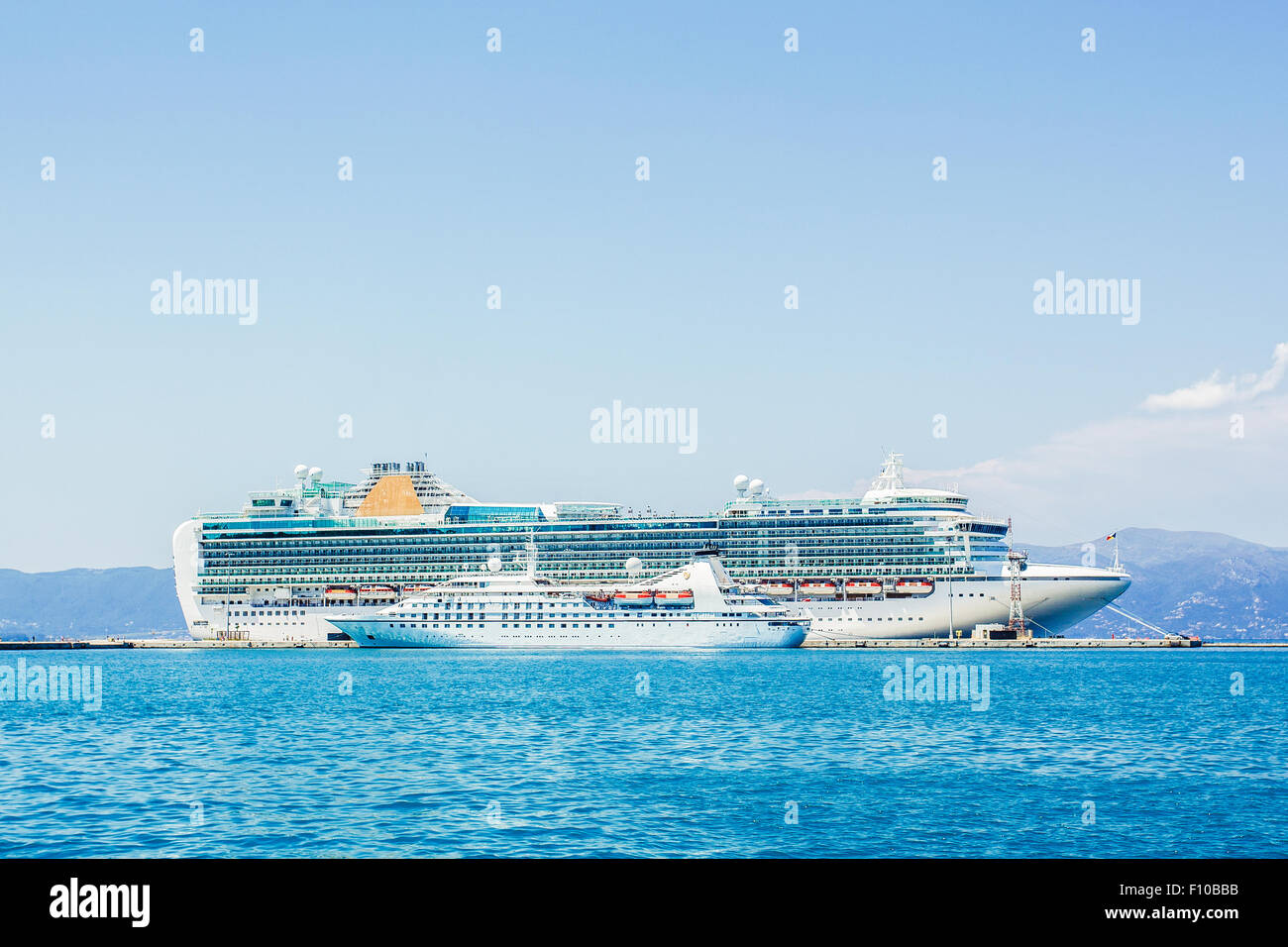 Luxury cruise ship docked at port. Cruise liner anchored at seaport of Corfu, Greece. Stock Photo