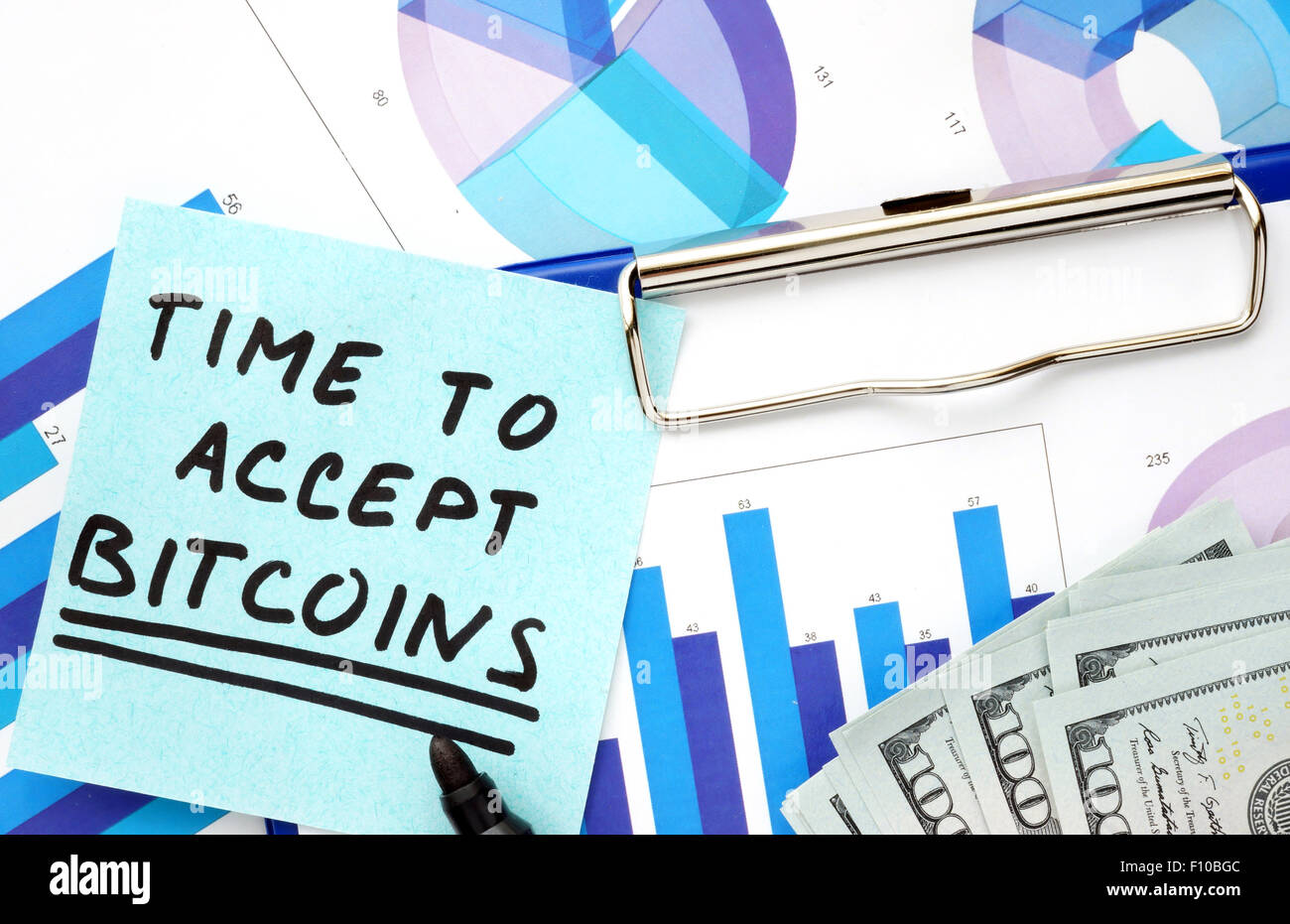 Paper with words time to accept bitcoins and graphs. Stock Photo