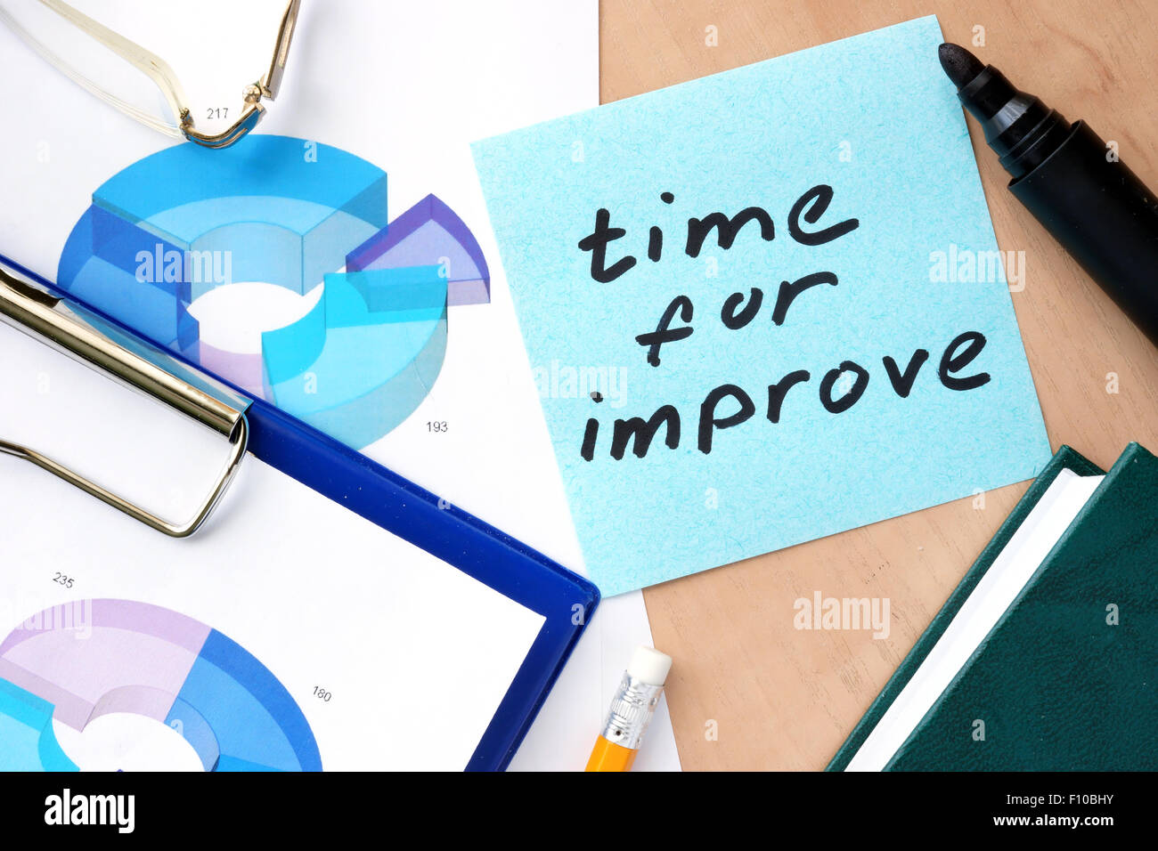 Paper with words time to improve and charts Stock Photo - Alamy