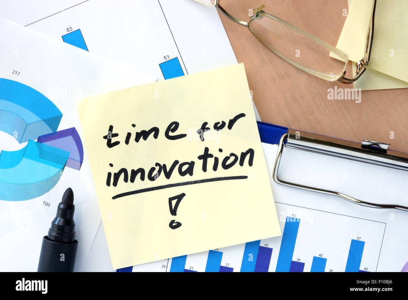 Paper with words time for innovation and charts. Stock Photo