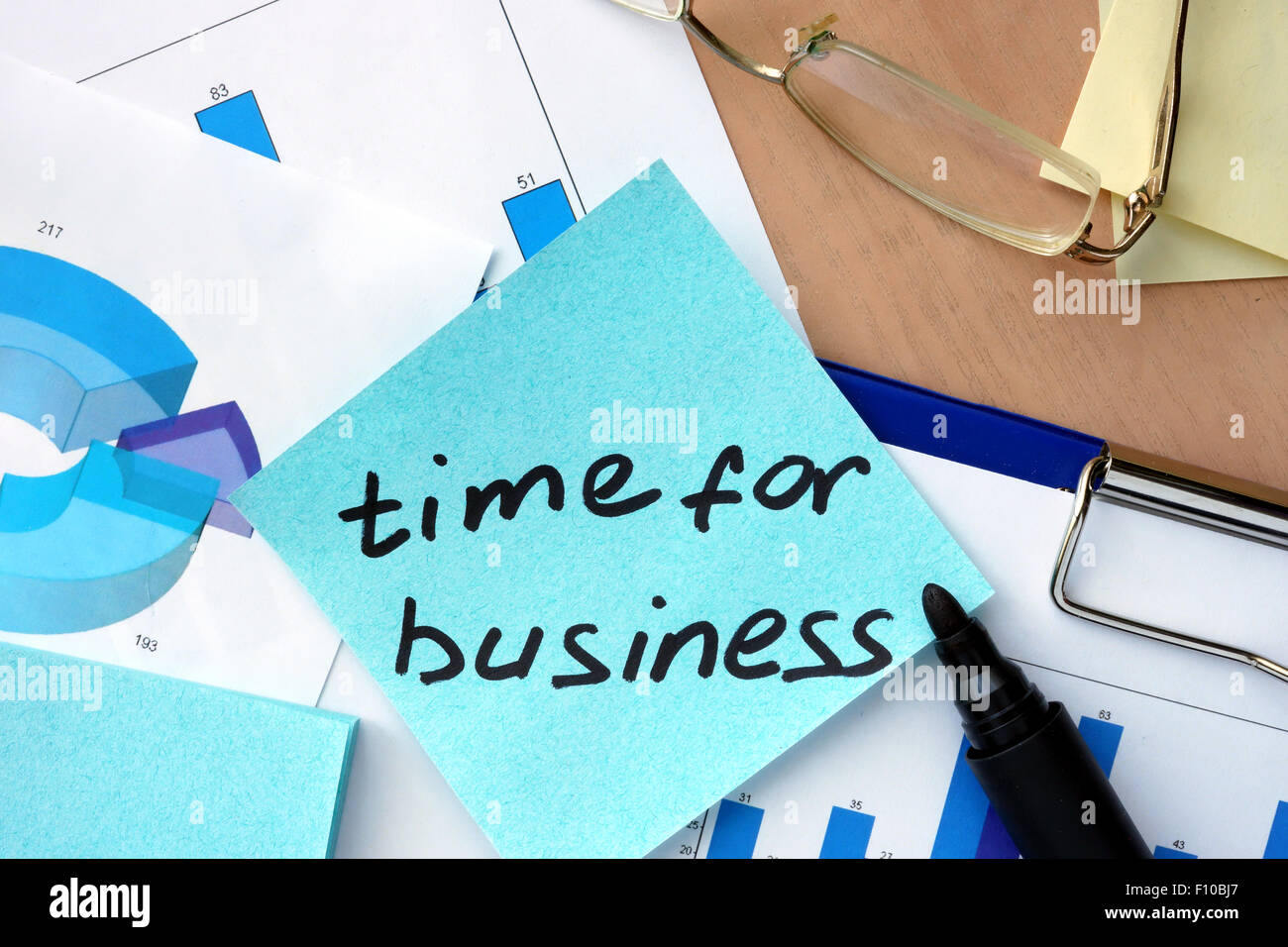 Paper with words time for business and charts. Stock Photo