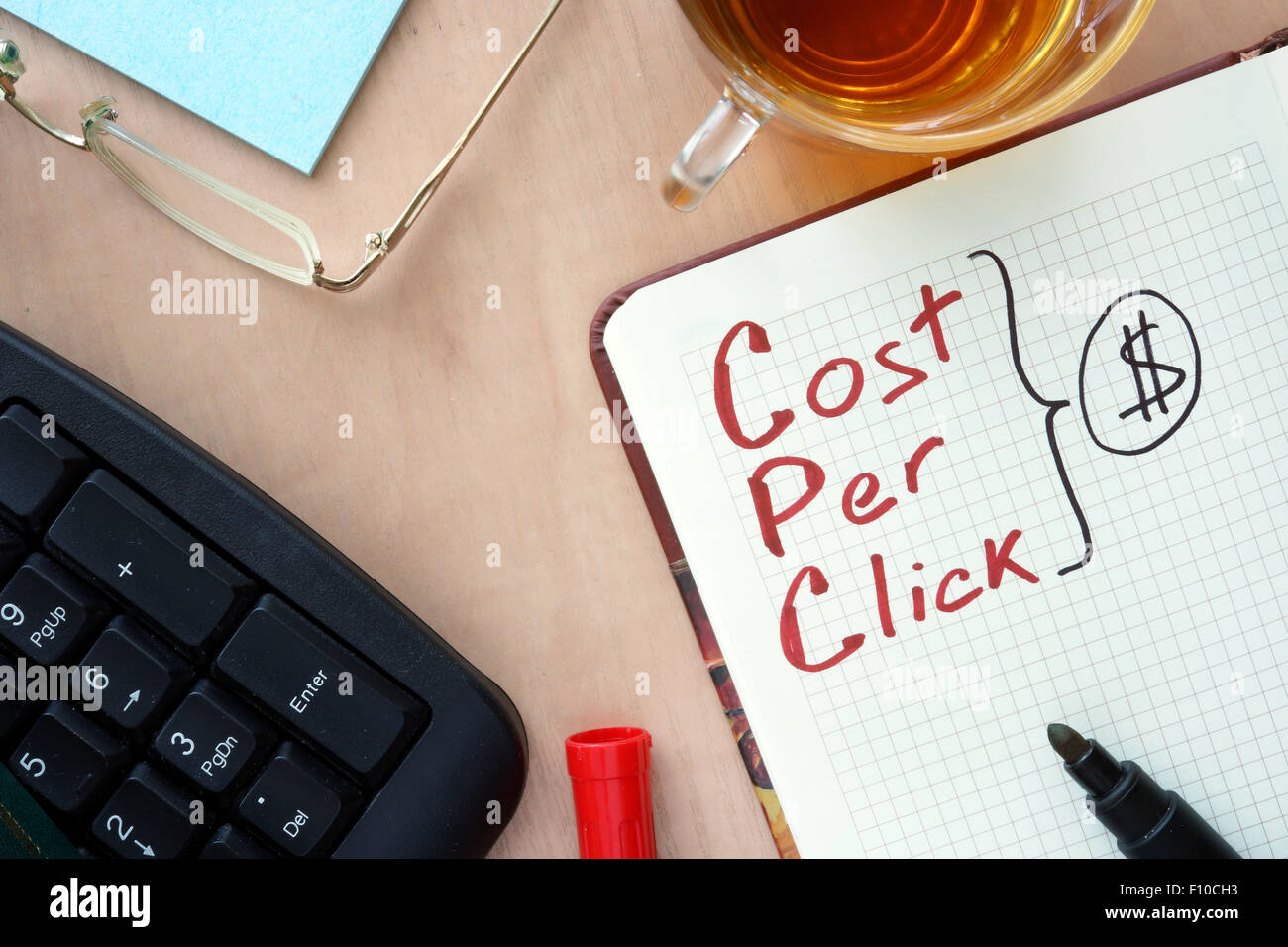 Notepad with word CPC cost per click  concept and marker. Stock Photo