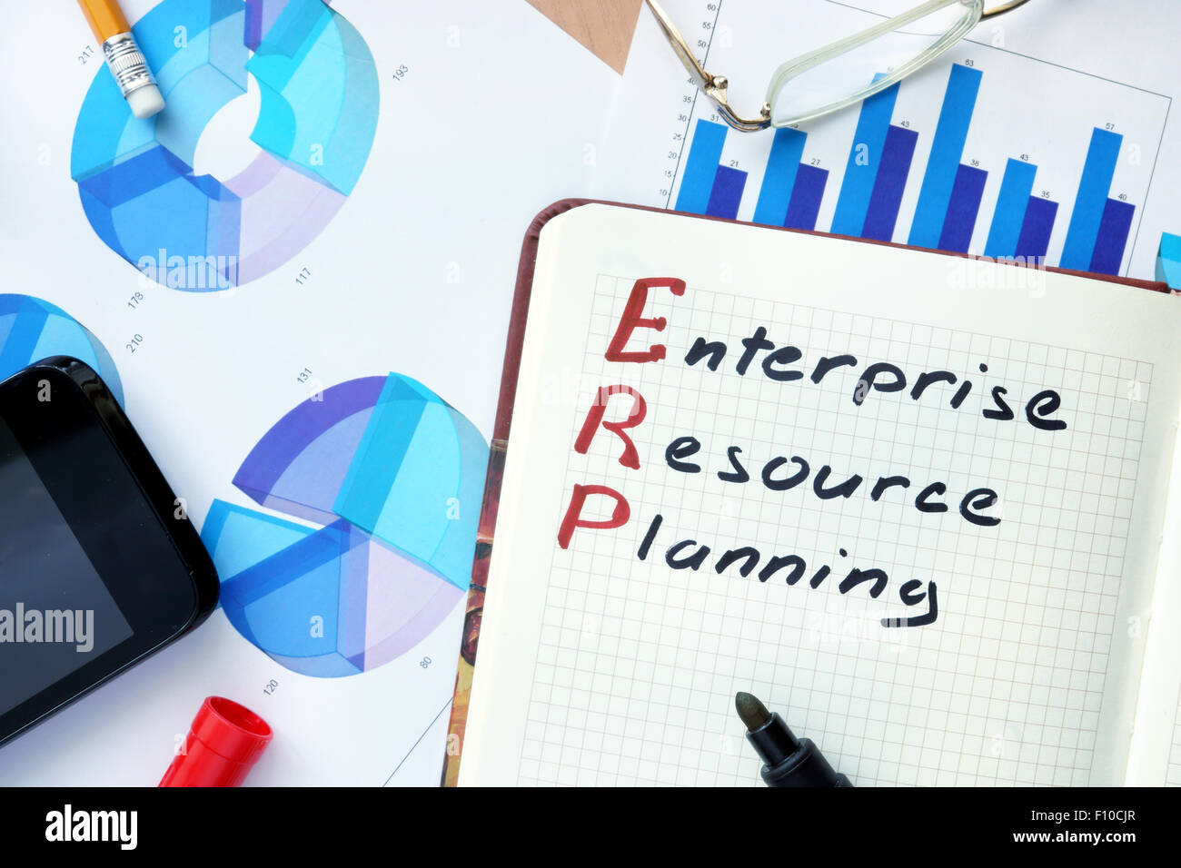 Notepad with word ERP enterprise resource planning concept and marker. Stock Photo