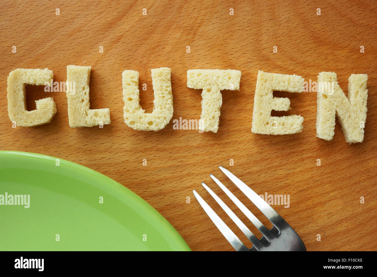 Word gluten from bread on a wooden board. Stock Photo