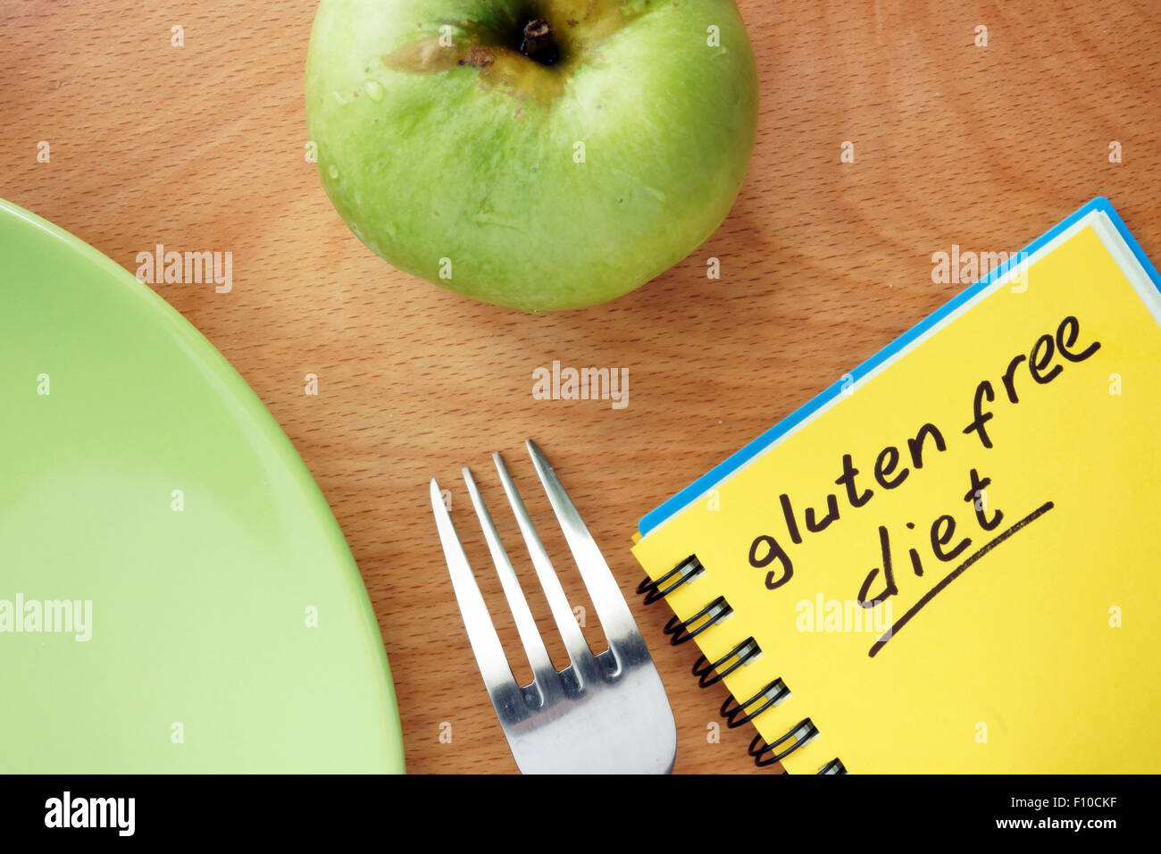 Notepad with words gluten free diet and apple. Stock Photo