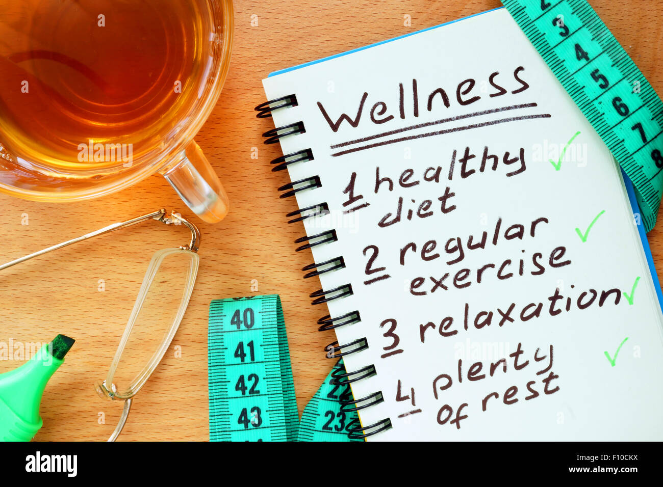 Notepad with  Wellness concept on a wooden board. Stock Photo