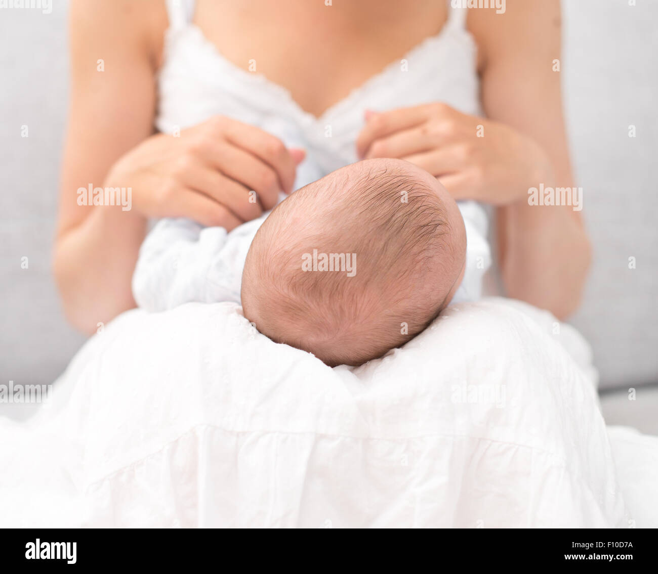 Mother is holding newborn baby on her knees Stock Photo Alamy