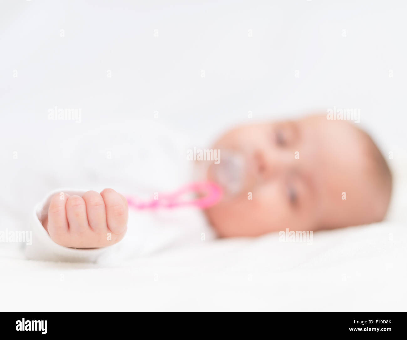 Newborn little baby with dummy sleeping on the bed Stock Photo Alamy