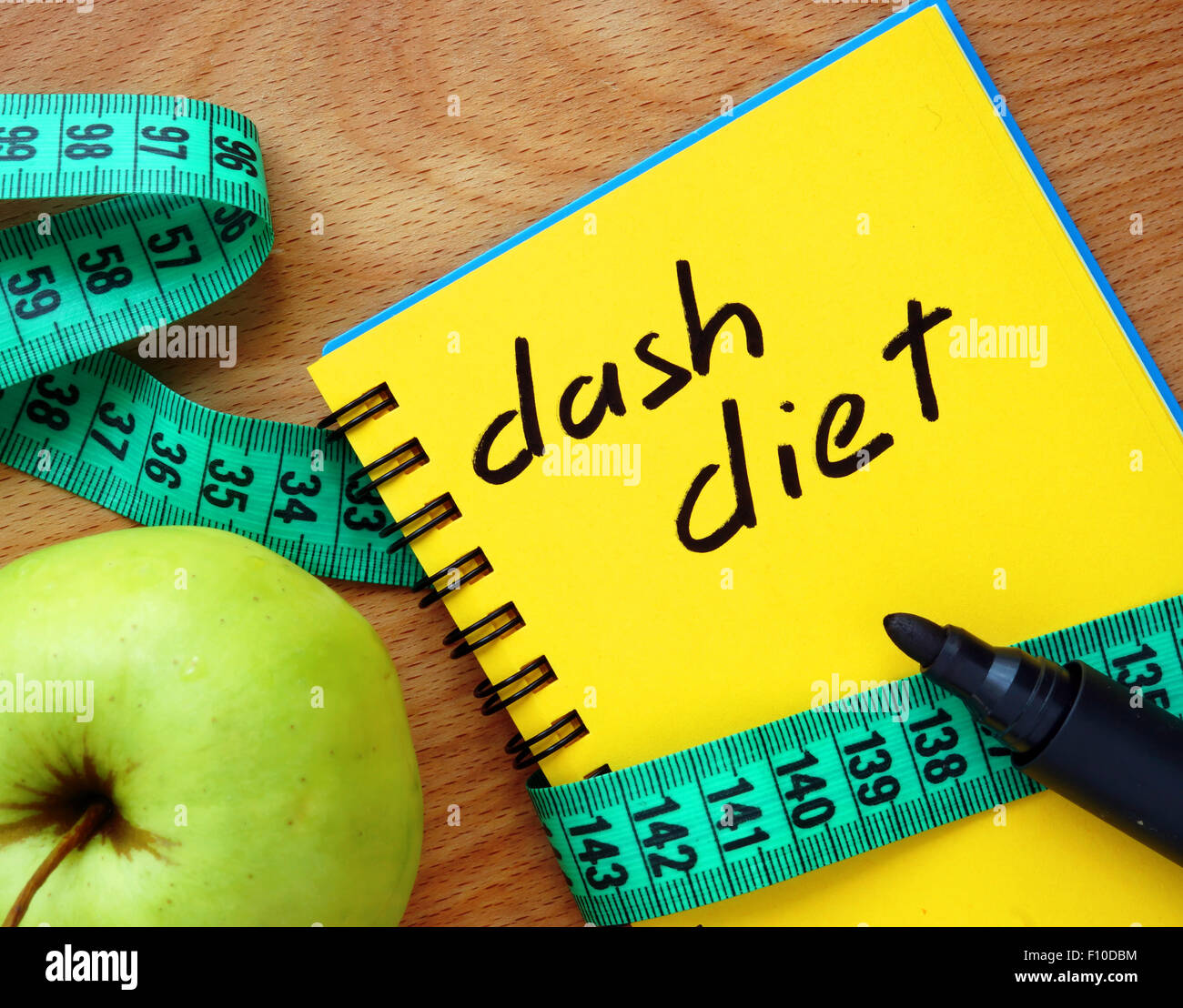 Notepad with dash diet, apple and measure tape Stock Photo
