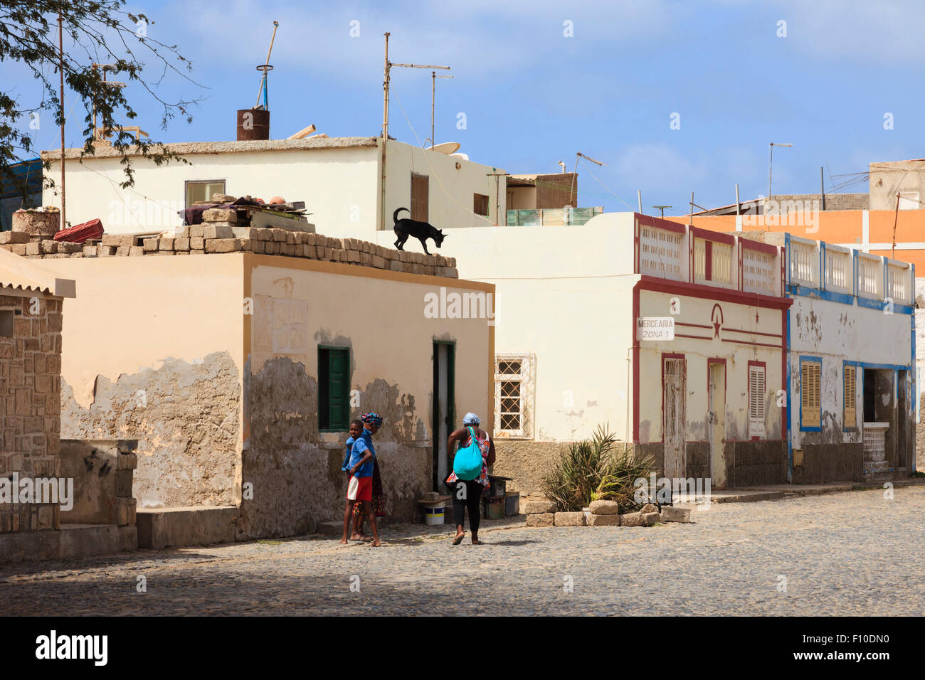 Typical street scene with colonial houses along cobbled road in capital city. Sal Rei, Boa Vista, Cape Verde Islands, Africa. Stock Photo