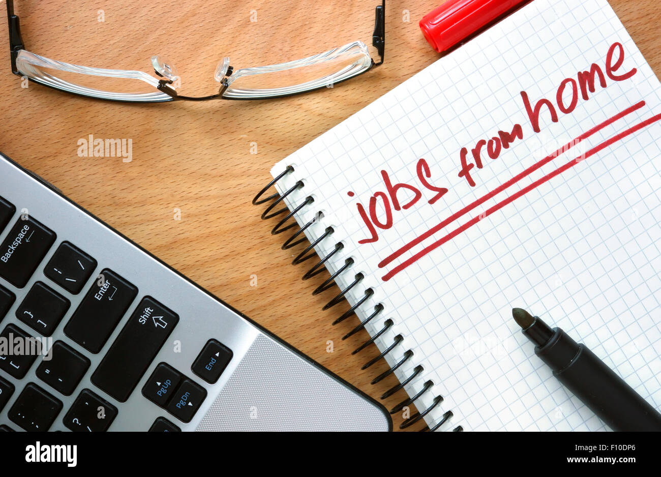 Notepad with words jobs from home on a wooden background Stock Photo