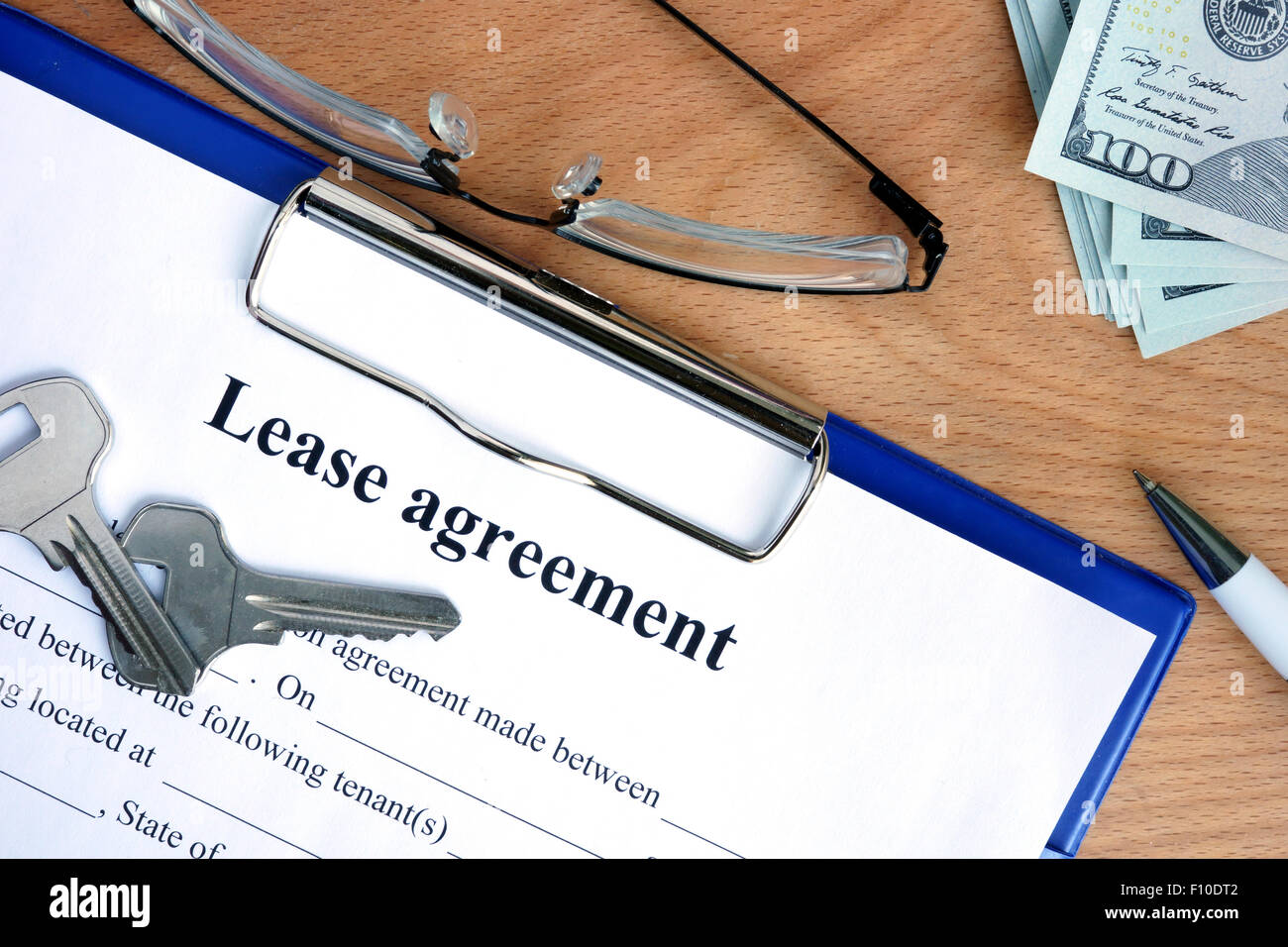 Lease agreement document with money on a wood background Stock Photo