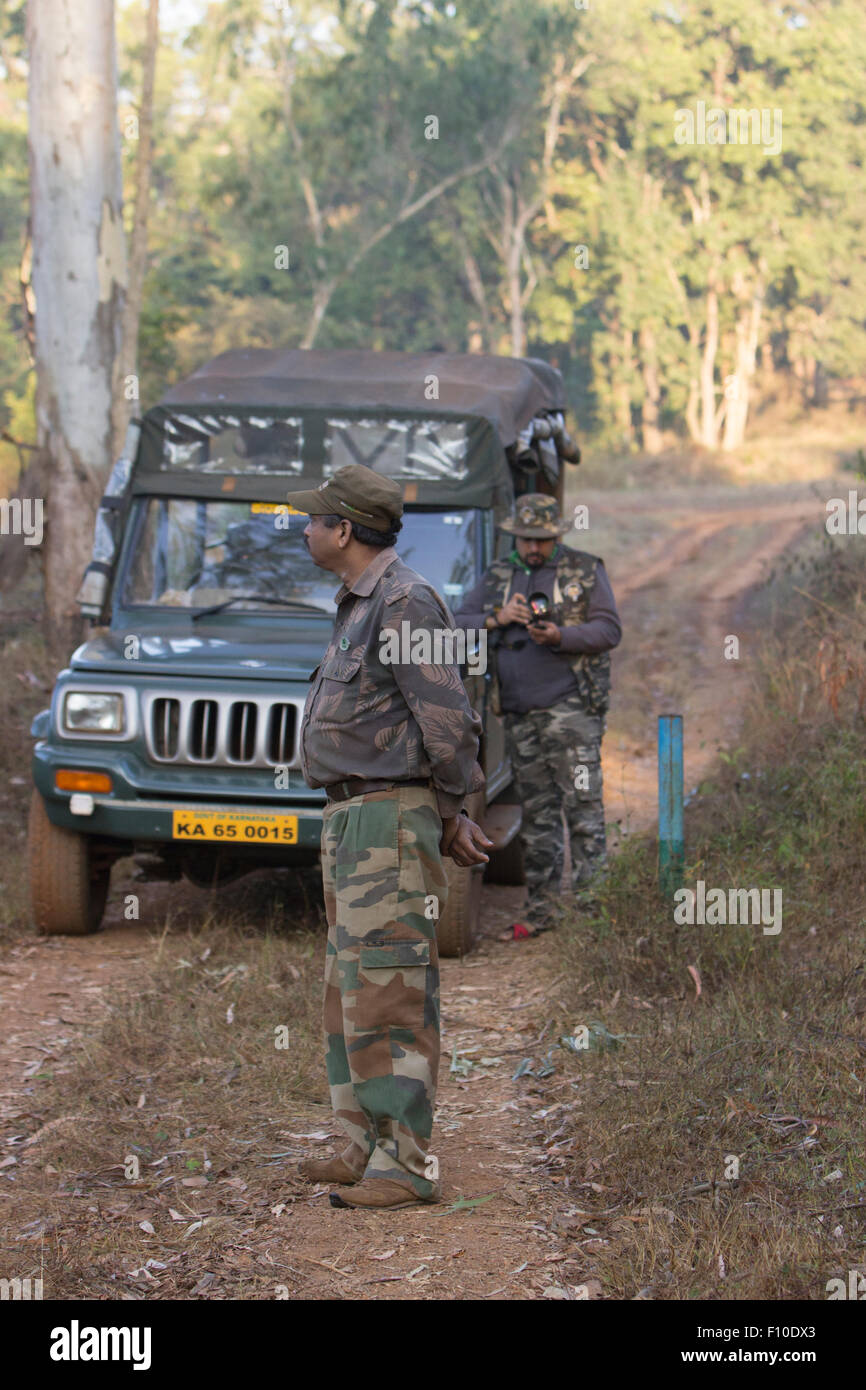 Forest ranger and a photographer in Dandeli Wild Life Sanctuary in the UNESCO Heritage site looking out for wild animals Stock Photo