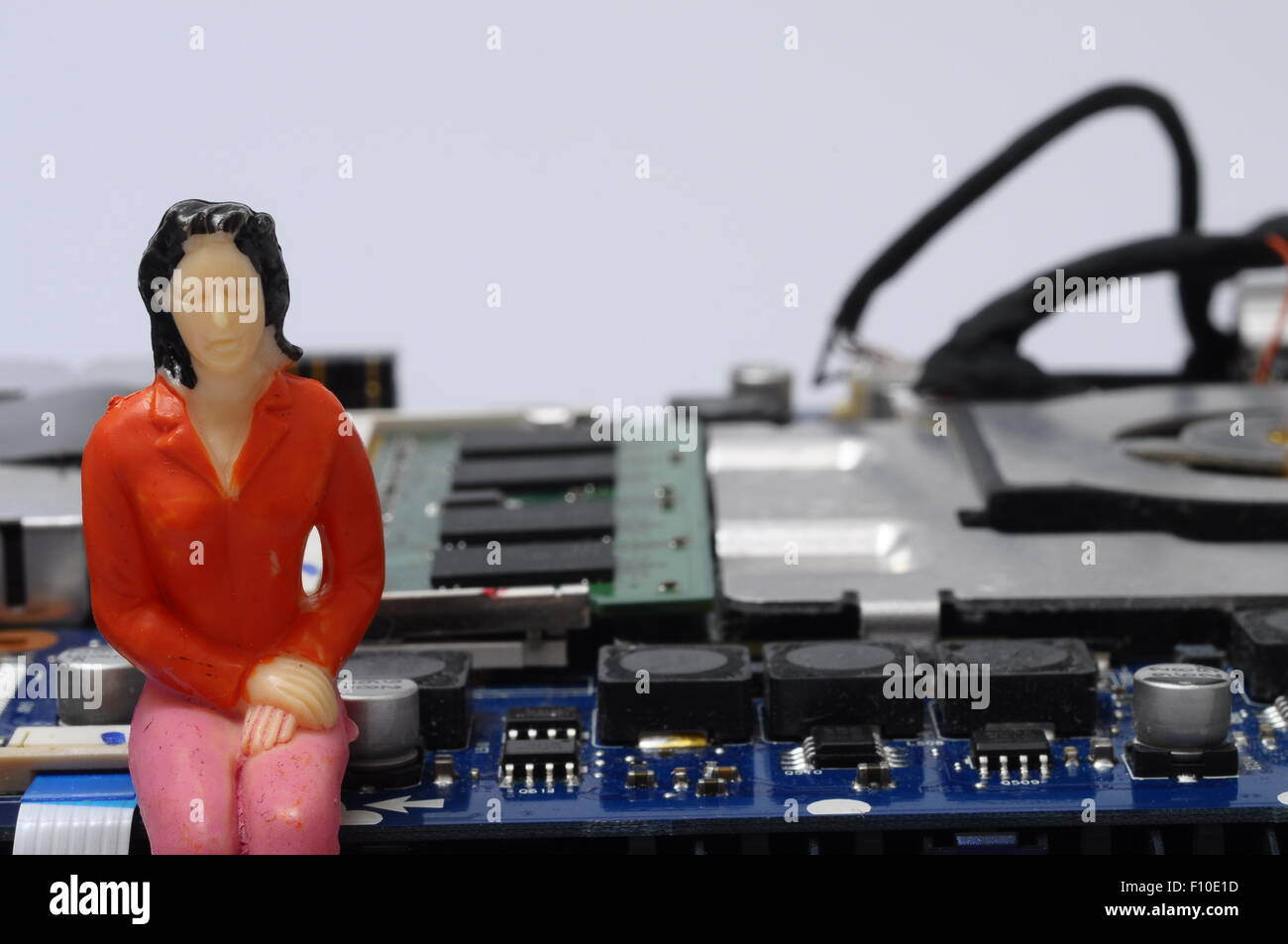 Close up of Disassembled computer components and people  figurines Stock Photo