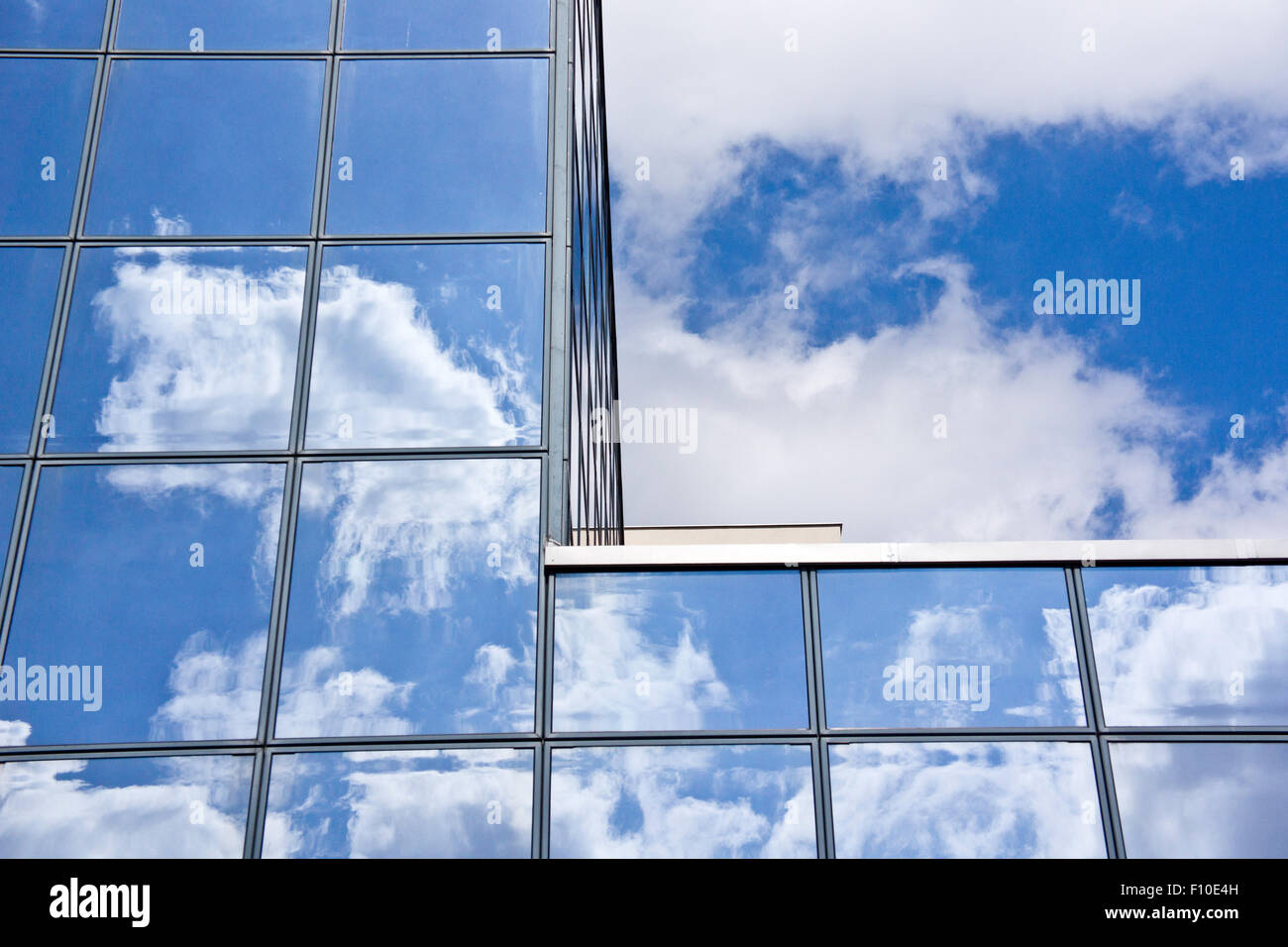 modern glass building with clouds reflecting Stock Photo