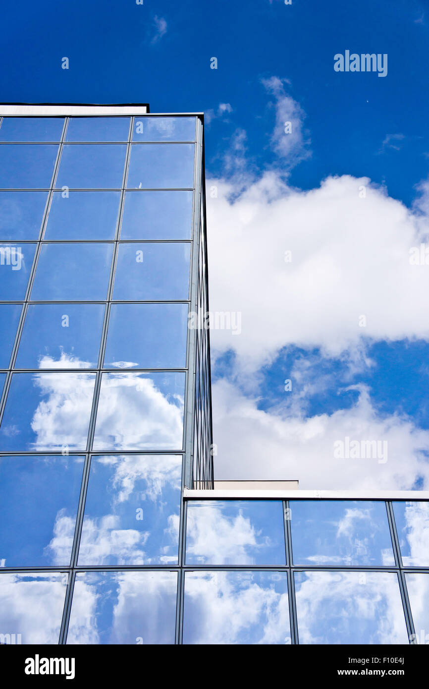 modern glass building with clouds reflecting Stock Photo