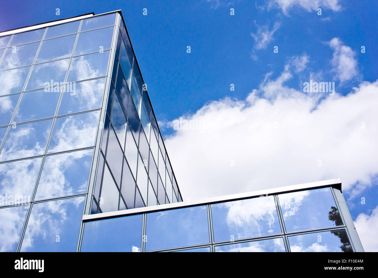 modern glass building with clouds reflecting Stock Photo