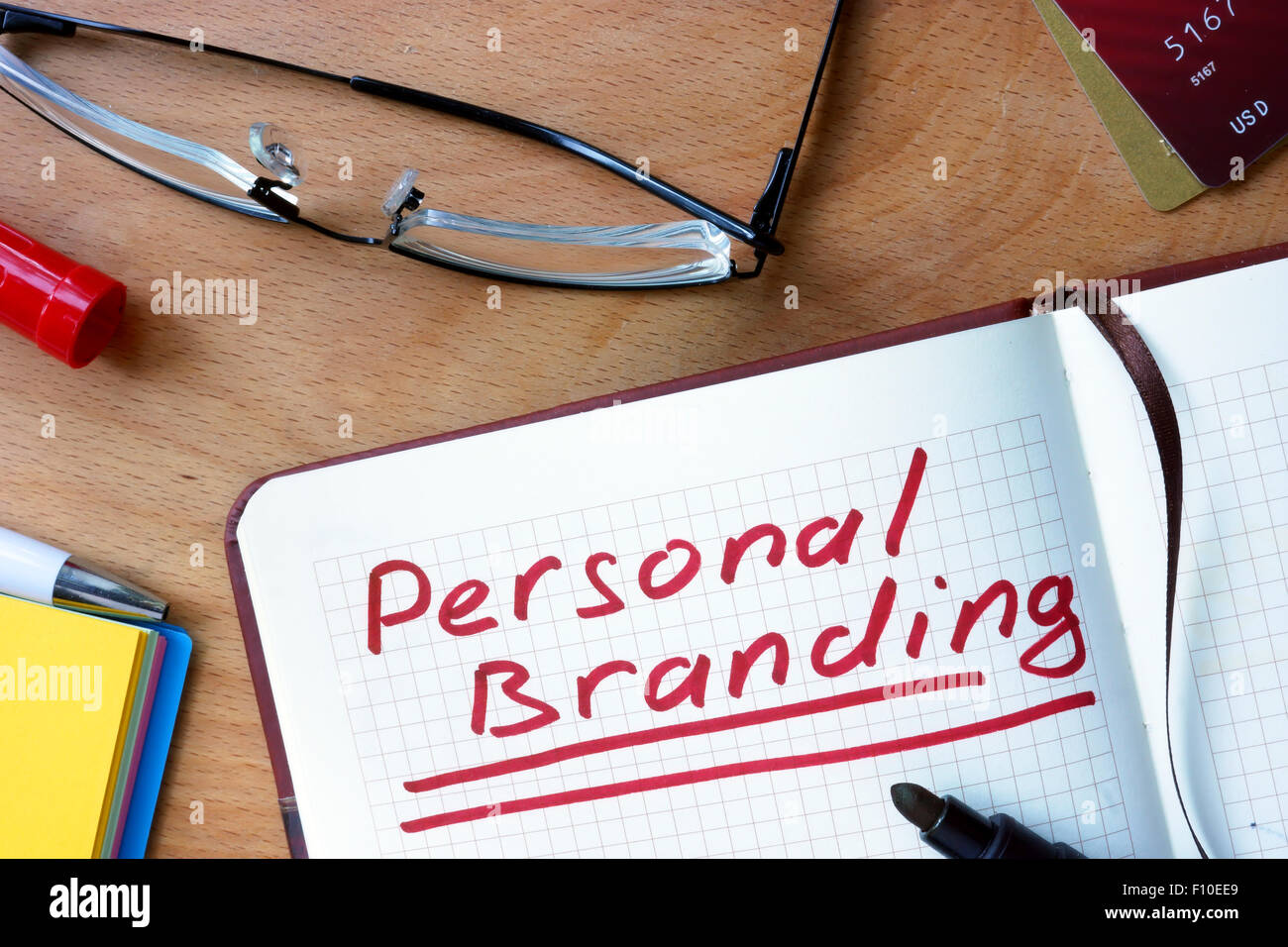 Notepad with  Personal Branding on office wooden table. Stock Photo