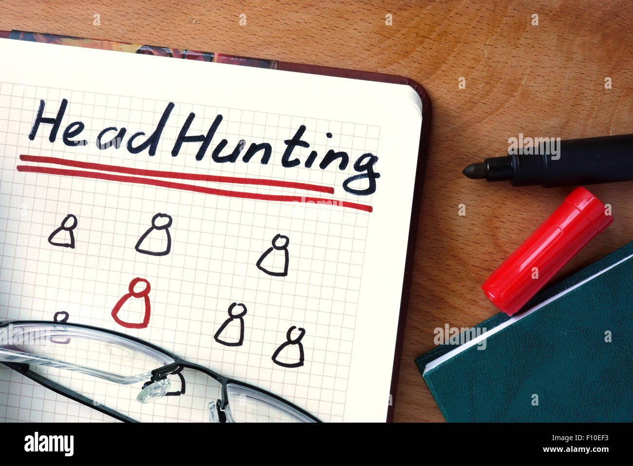 Notepad with Headhunting on office wooden table. Stock Photo