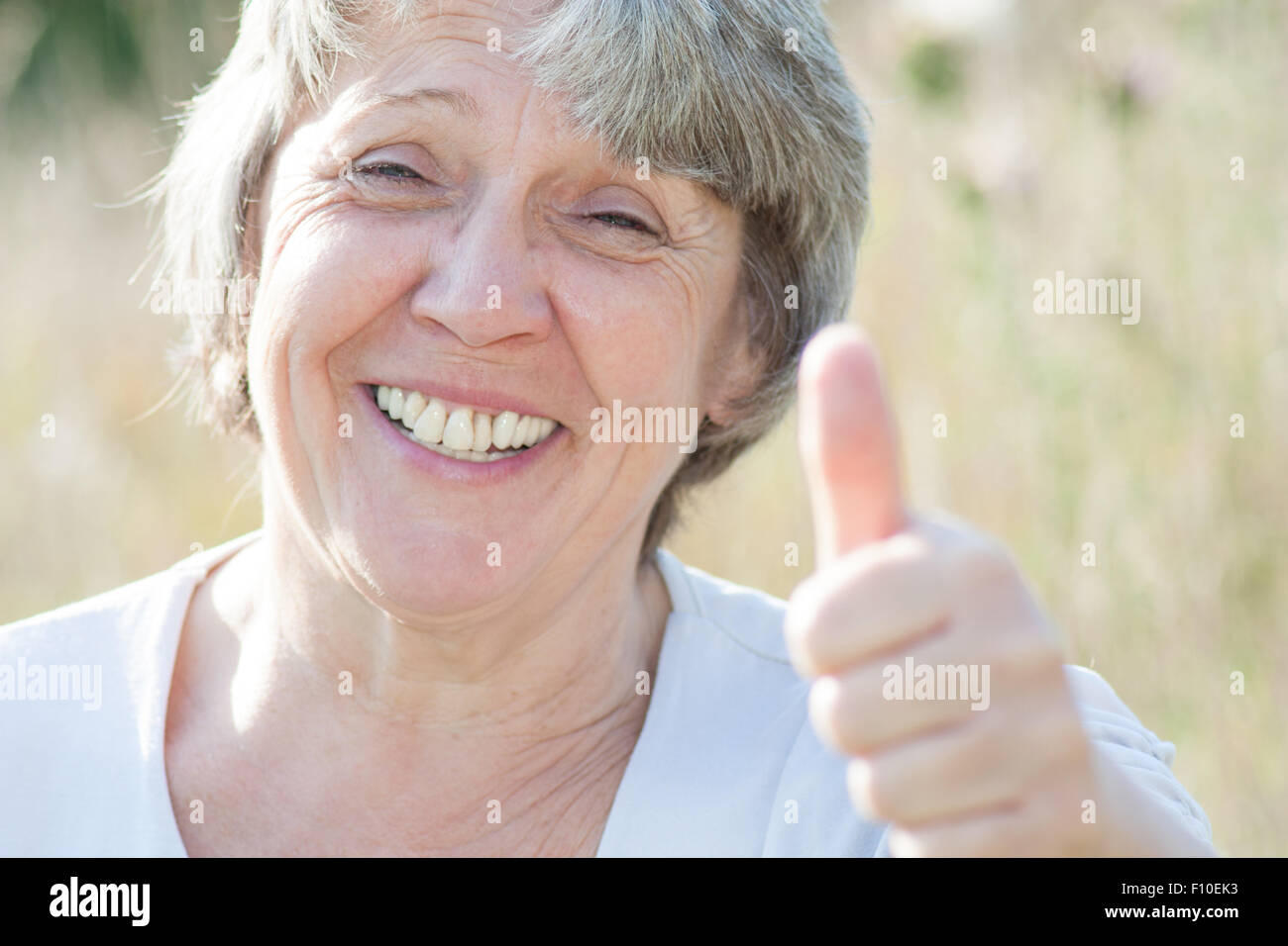 Old age woman showing thumbs up Stock Photo